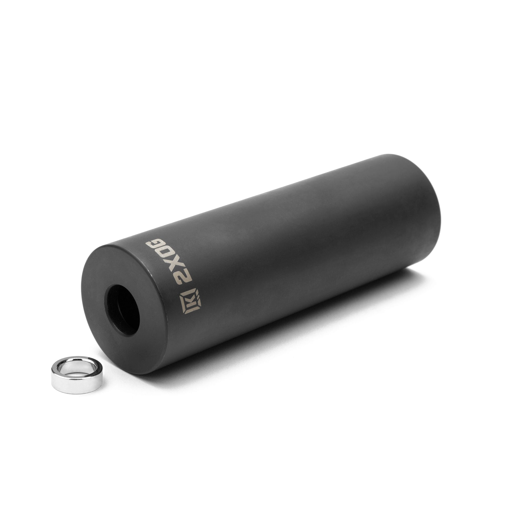 A matte black Kink 2XOG Peg (4.5 Inch), cylindrical and durable, is shown with a small metal ring beside it on a white background.