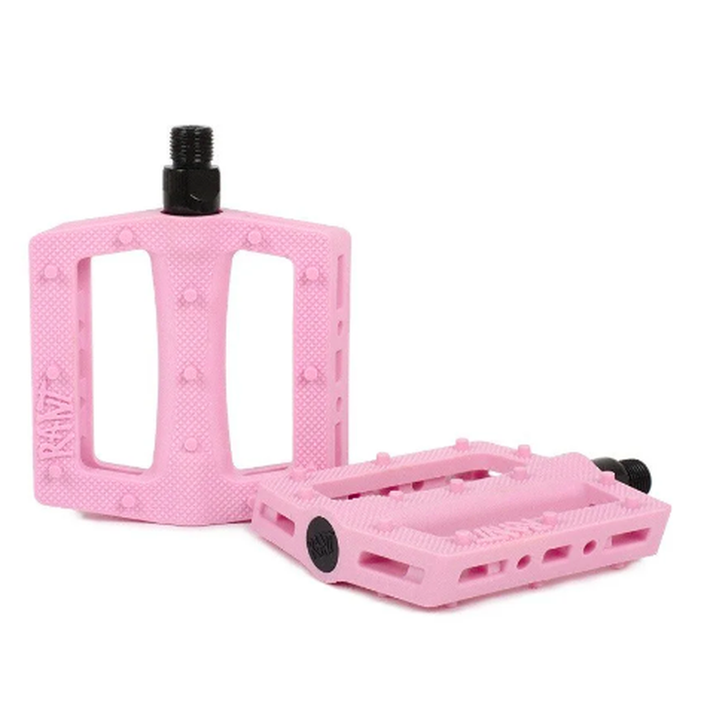A pair of pink Rant Trill Plastic Pedals with a chromoly axle on a white background.