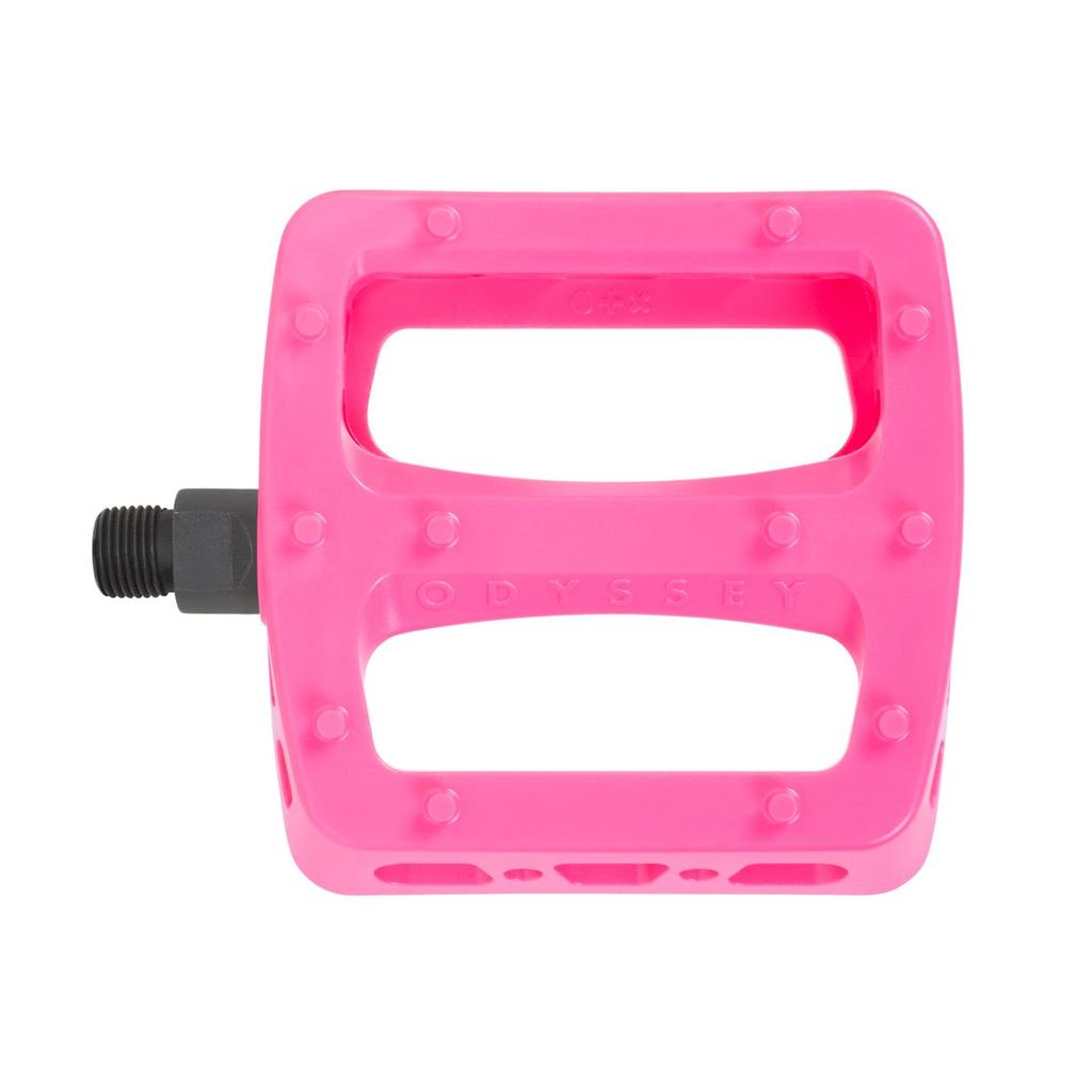 Odyssey Twisted PC Pro Pedals in bright pink feature a rectangular shape, visible grip studs, and a left-side black axle. Made from durable nylon composite, these BMX pedals are shown against a white background.