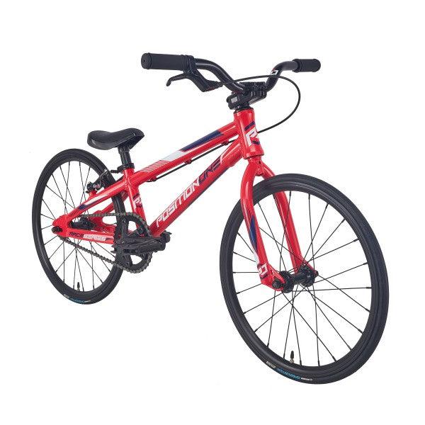 A speedy red Position One Micro 18 bike on a white background.