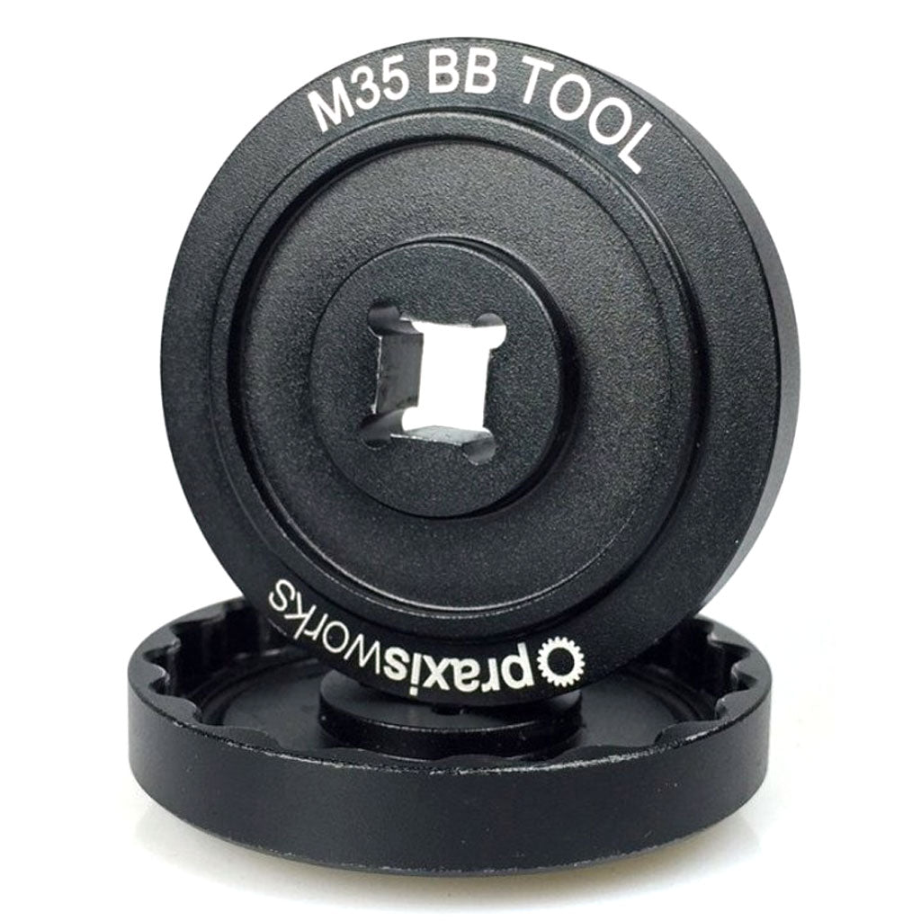The Praxis M35 BB Tool is a black metal bottom bracket tool with "M35 BB TOOL" and "praxisworks" printed on it, designed for precise bike maintenance and crank installation.