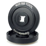 The Praxis M35 BB Tool is a black metal bottom bracket tool with "M35 BB TOOL" and "praxisworks" printed on it, designed for precise bike maintenance and crank installation.
