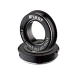 A lightweight black First BB86 Press Fit Alloy Cup Bottom Bracket bearing with the word first on it.