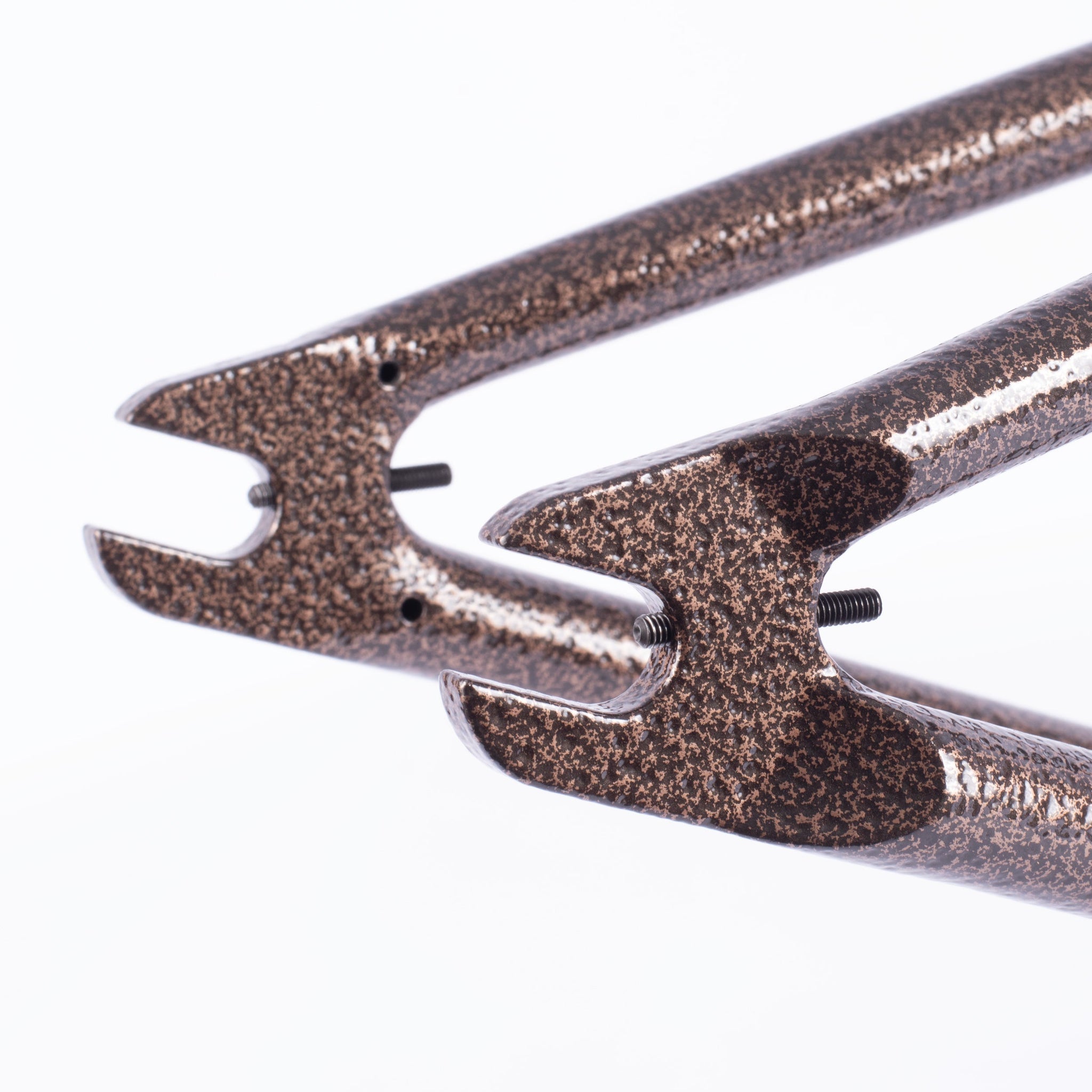 Close-up of a metallic Cult Walsh Frame (Preston Okert Signature) dropout with a speckled brown and black finish, highlighting the rear wheel attachment points.