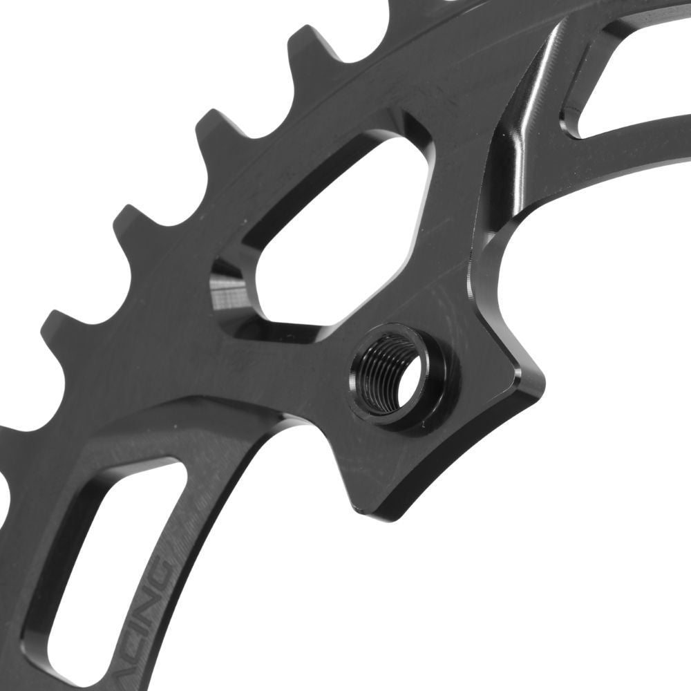 Close-up of a PRIDE Newton C1 4 Bolt Chainring / Threaded, made from black 7075-T6 aluminum, featuring a threaded hole and cut-out sections, set against a white background.