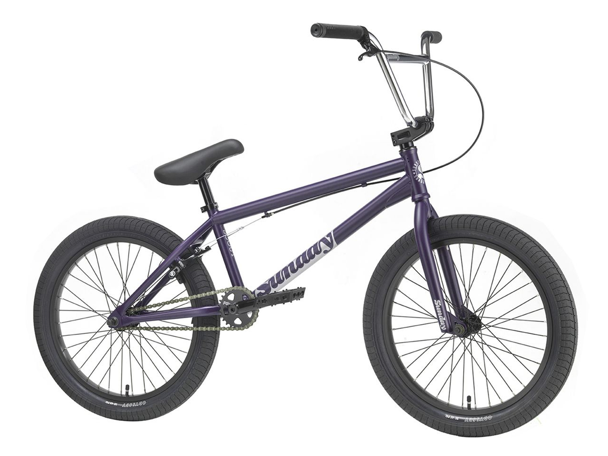 A Sunday Scout 20 Inch Bike in purple is displayed from the side on a white background, featuring black handlebars, seat, and tires. The frame has a 20.75TT size, making it ideal for versatile riders.