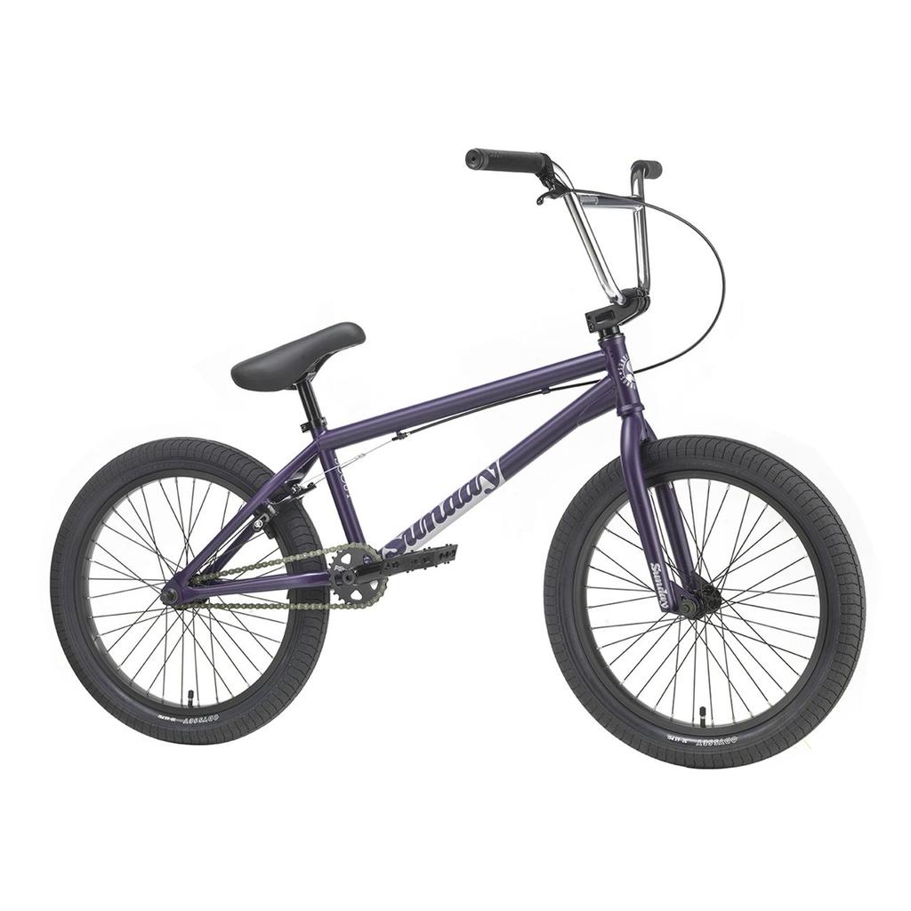 A Sunday Scout 20 Inch Bike in purple is displayed from the side on a white background, featuring black handlebars, seat, and tires. The frame has a 20.75TT size, making it ideal for versatile riders.