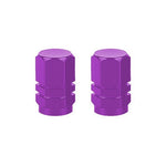 The Hexagon Valve Caps (Pair) boast a vibrant purple color and sleek metallic finish, adding style to every ride.