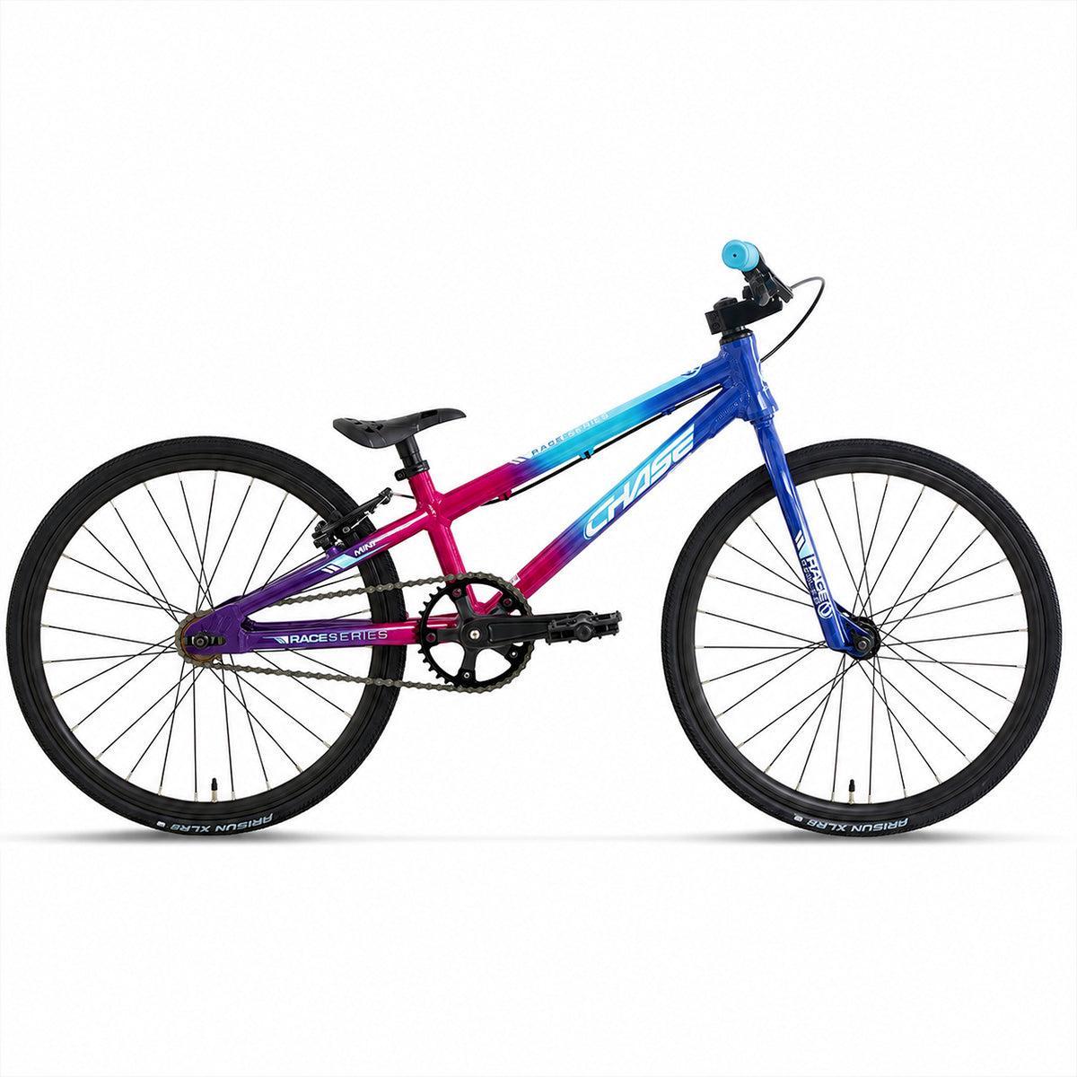 The Chase Race Series Mini Race Bike (2027) is an entry-level BMX featuring a gradient pink-to-blue frame, complemented by black handlebars, saddle, and wheels, shown against a white background.