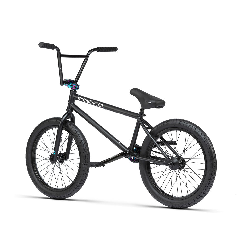 The Radio Comrad 20 inch BMX bike features a full Cromoly frame, thick tires, a straight handlebar, and a padded seat. It is angled to the right on a white background for an image of durability and precision.