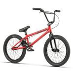 Description: Red BMX bicycle with a black seat, black handlebars, and Salt Tracer Tyres. The minimalist Radio Dice 20 Inch Bike comes equipped with front and back pegs for performing tricks.