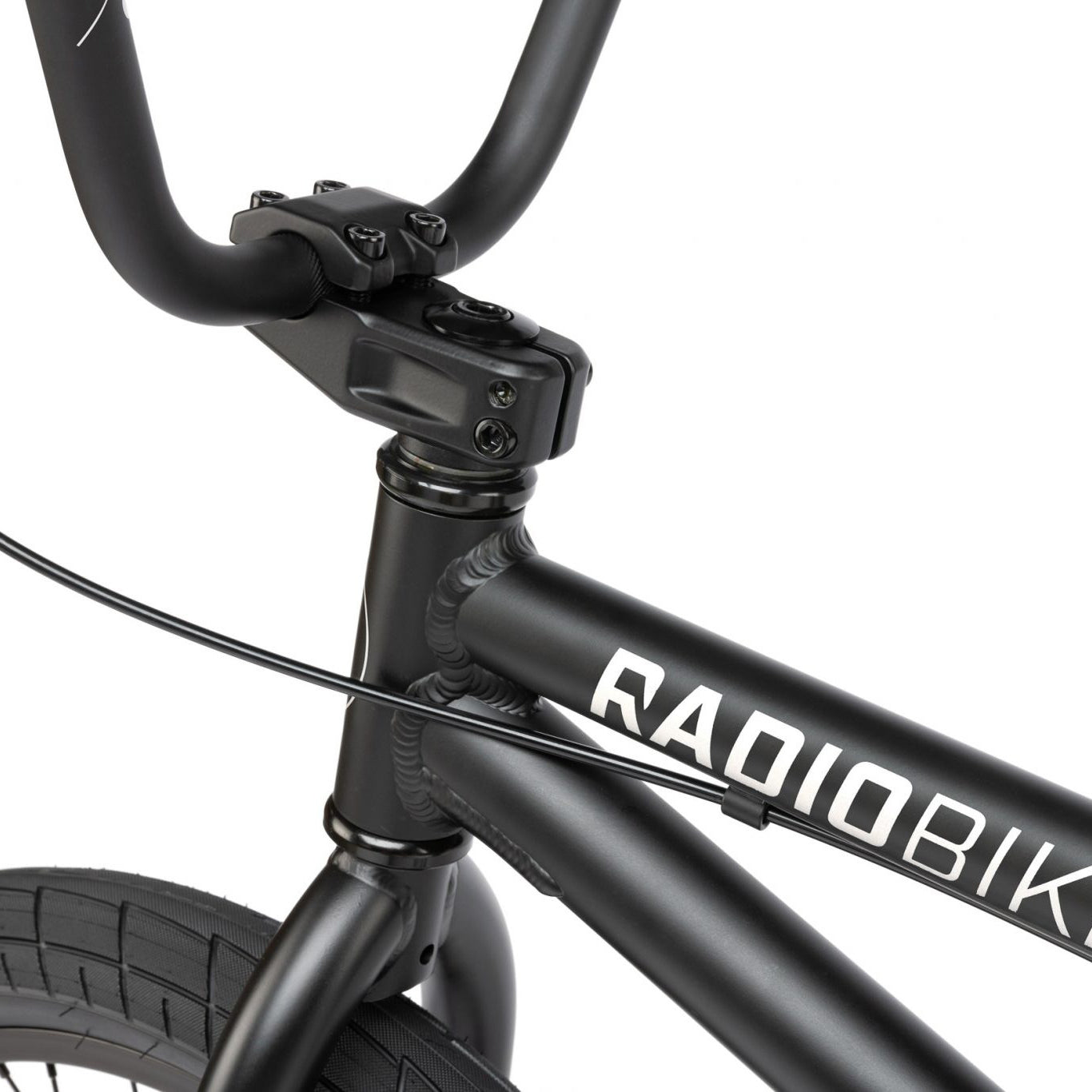 Close-up of the front section of a black Radio Dice 20 Inch Bike, showcasing the handlebars, part of the 6061 Alloy Frame, and the brand name "RADIOBIK".