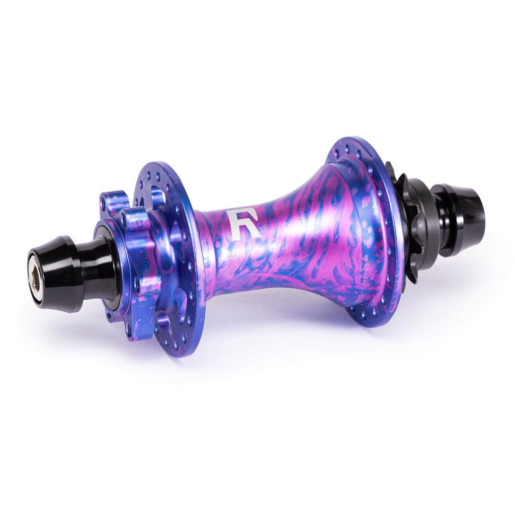 The Radio Sonar Rear MTB Hub showcases a vibrant purple and pink swirl with black axle ends, a central R logo, and an integrated MagnaDrive magnetic pawl retention system for enhanced performance.