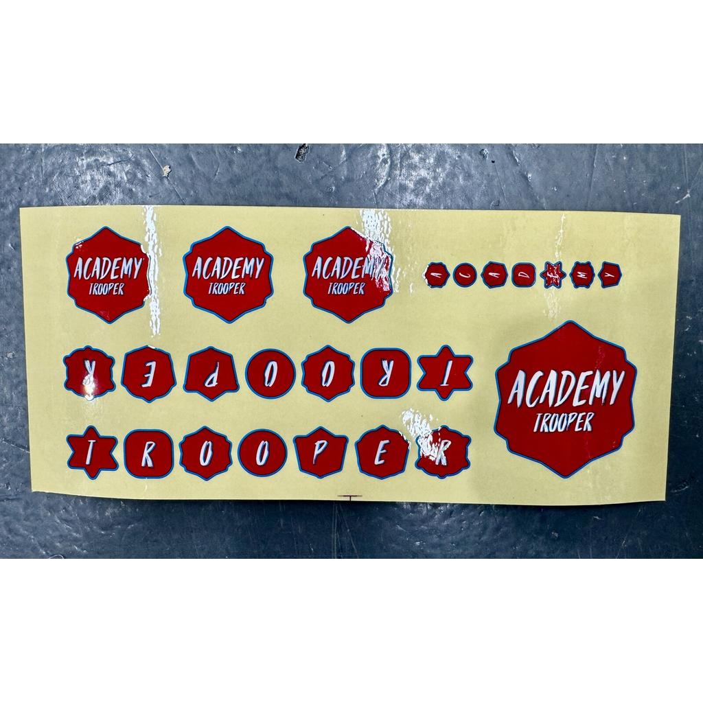 A sheet of red and blue Academy Trooper Sticker Pack decals in various shapes and sizes for kids BMX bikes.