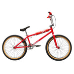 The Fit Bike Co Series 22 Inch Bike is shown in profile, featuring a red frame, black seat, black handlebars with red grips, and tan-walled tires, all set against a white background.