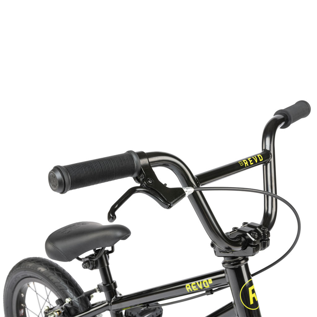 A black and yellow Radio Revo 14 Inch bike focusing on the handlebar and brake lever. The Radio Revo 14 Inch bike features a padded seat and a portion of the rear wheel, making it an ideal first bike.