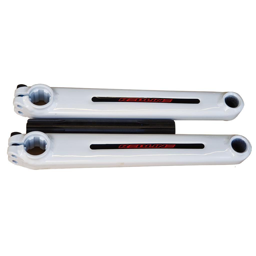 Two white Redline Flight Cranks with "Redline" branding and a black spindle, displayed on a white background—an iconic chromoly crankset recognized among top BMX components.