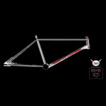 The Redline Proline Frame/Fork/Handlebar Kit, featuring a chrome bicycle frame with red and white accents and "Red Line" branding, is showcased against a black background. It is accompanied by a commemorative 50th anniversary Red Line logo plaque on the side.