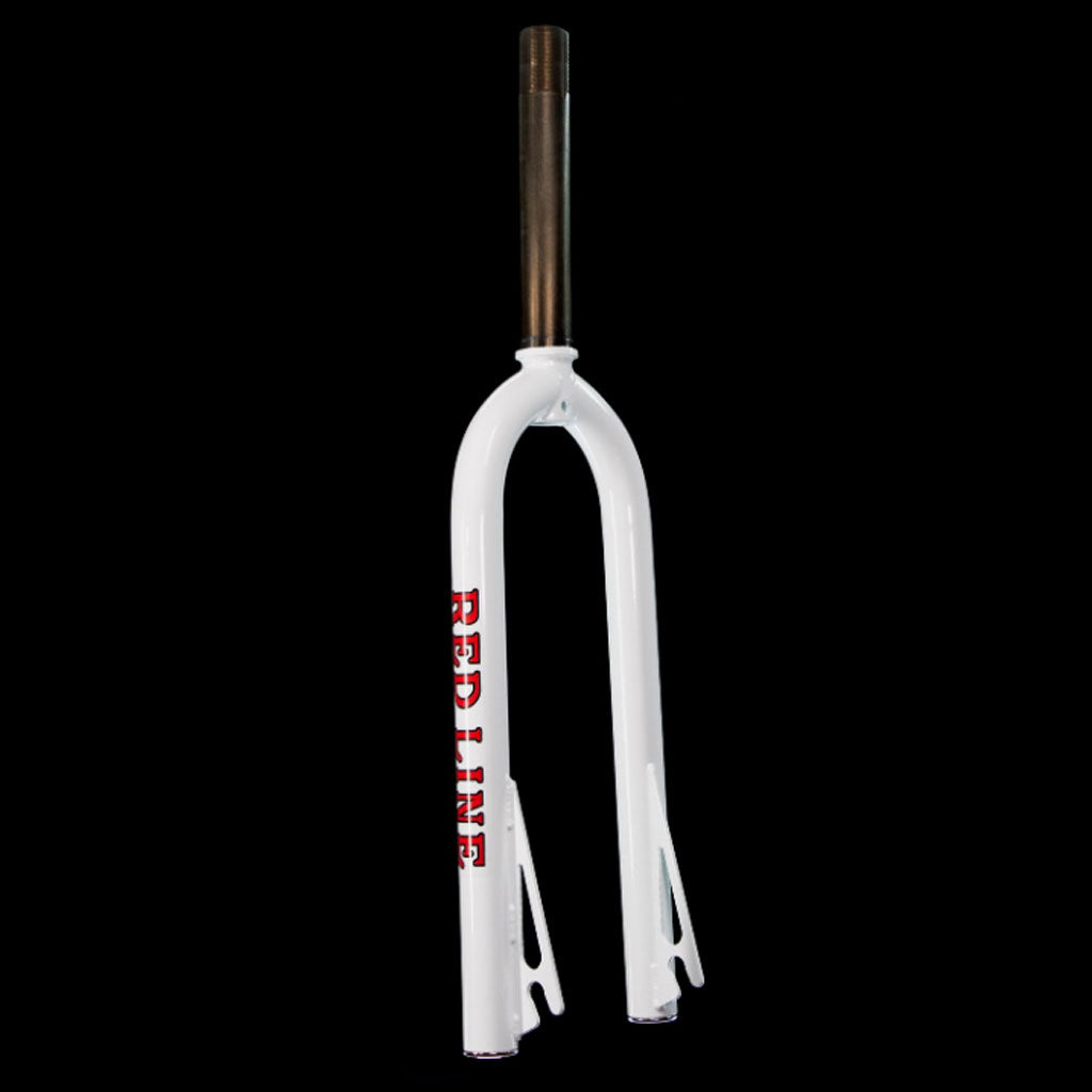 A white bicycle fork from the Redline Proline Frame/Fork/Handlebar Kit, featuring "REDLINE" written in red vertically on one leg, set against a black background.