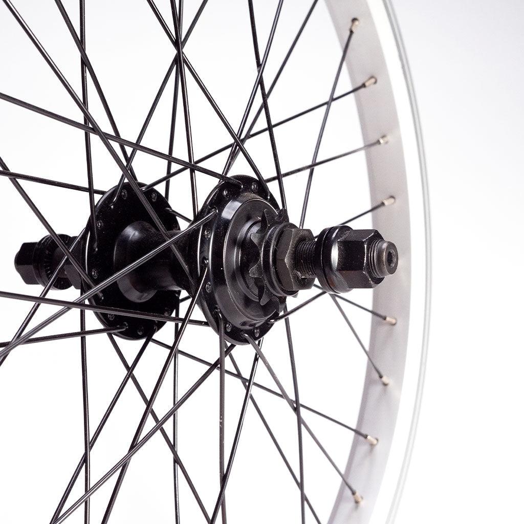 Close-up of a Redline RL 20 B Complete wheelset featuring a double wall rim, spokes, 14mm axle, and hub components with an RHD cassette against a white background.