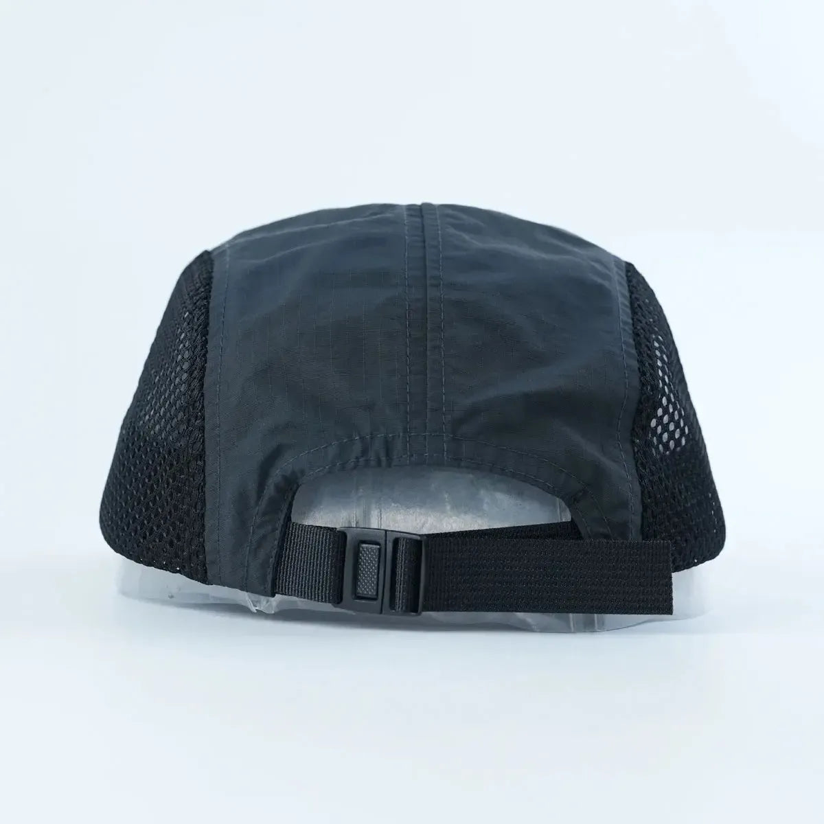 A Backbone Ride Club Hat, designed in black mesh, is displayed from the back and features an adjustable strap with a buckle closure against a plain light background.