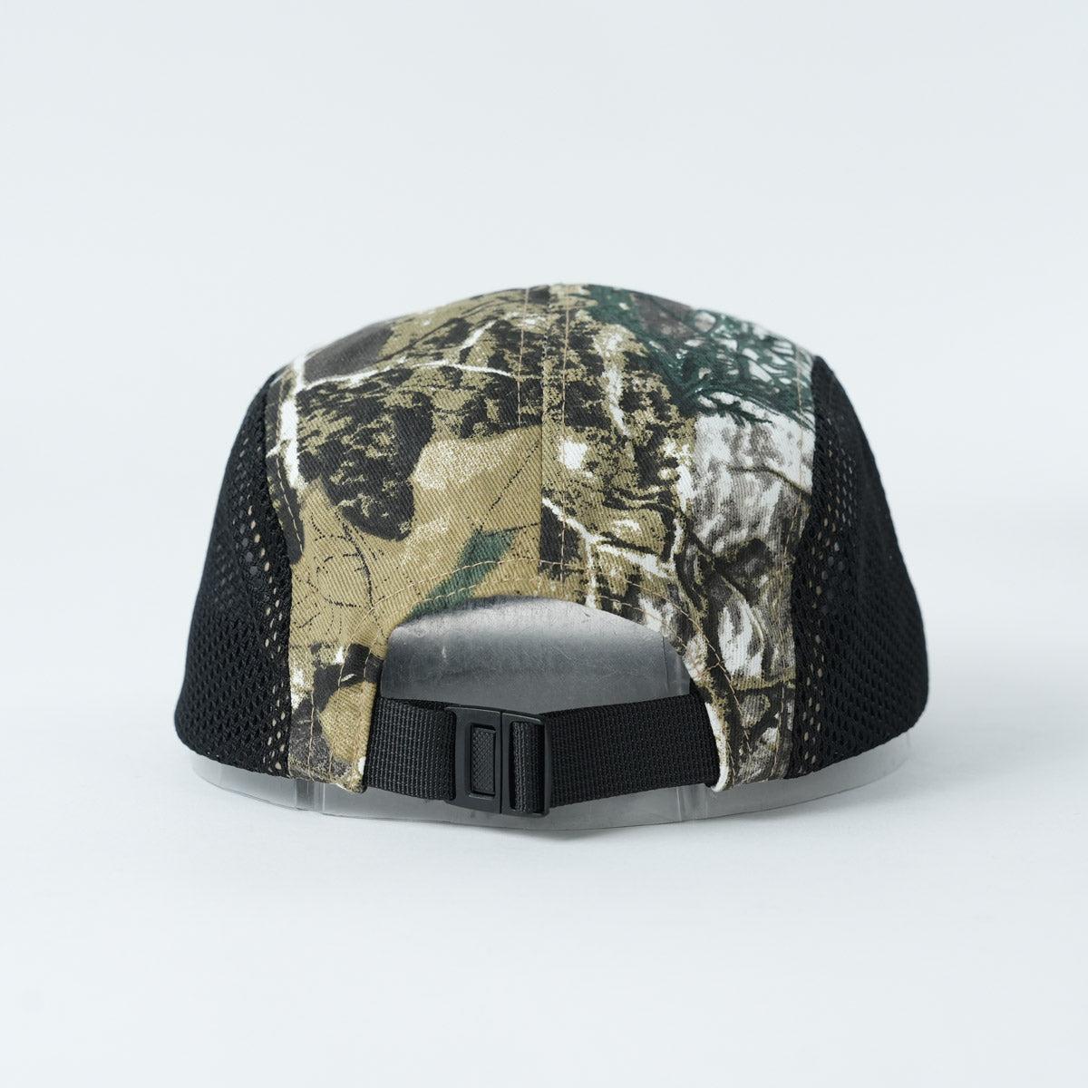 Back view of the Backbone Ride Club Hat showing its camouflage pattern, black mesh sides, and adjustable plastic strap.