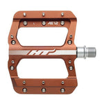 HT AE12 Pedals: Orange, flat design with EVO+ system, silver axle, metal pins for grip, and "HT AE12" branding. Precision CNC aluminium construction ensures durable performance.