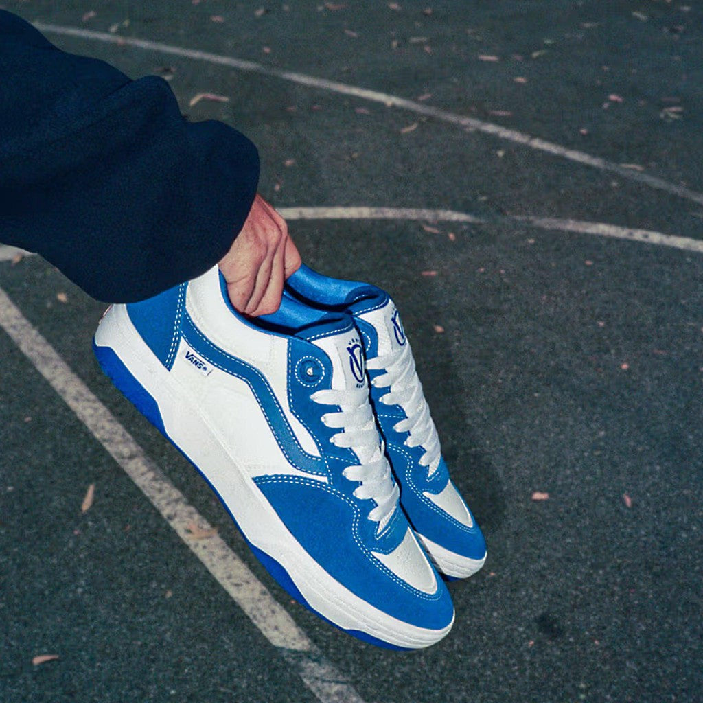 A person holding Vans Rowan 2 Shoes True Blue/White on a basketball court for impact protection.