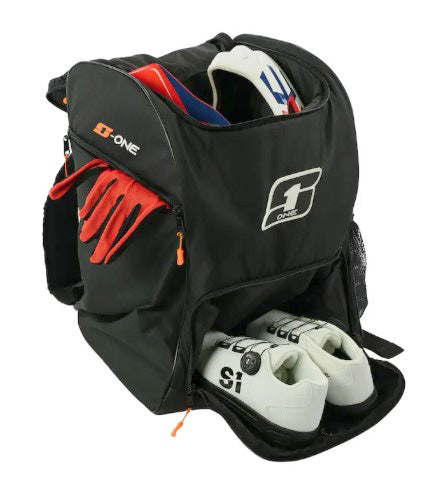 A black S1 Helmet / Gear Backpack with red gloves, white cycling shoes, helmet gear, and protective equipment neatly packed inside and partially visible.