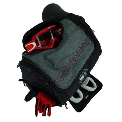 A black and gray S1 Helmet / Gear Backpack is open, showing red goggles, red gloves, and a white item inside. It has a zippered front pocket and a rectangular patch—ideal for organizing your gear essentials.