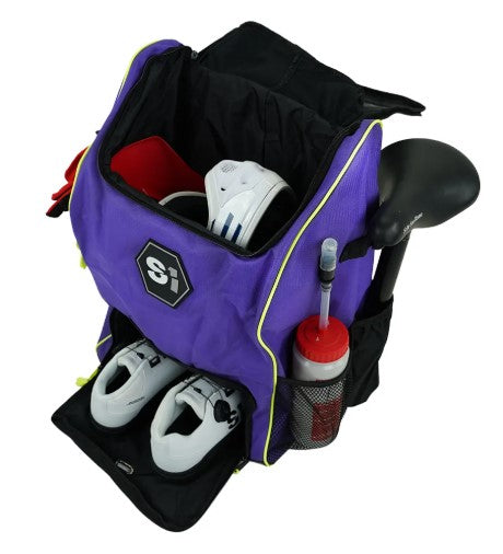 An S1 Helmet / Gear Backpack holds a pair of white shoes, a red towel, and a water bottle in the side mesh pocket, plus features an open compartment for storage.
