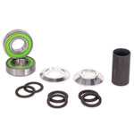 A Salt Plus Echo Mid Bottom Bracket with green accents, metal rings, rubber O-rings, and alloy CNC cones arranged on a white surface.