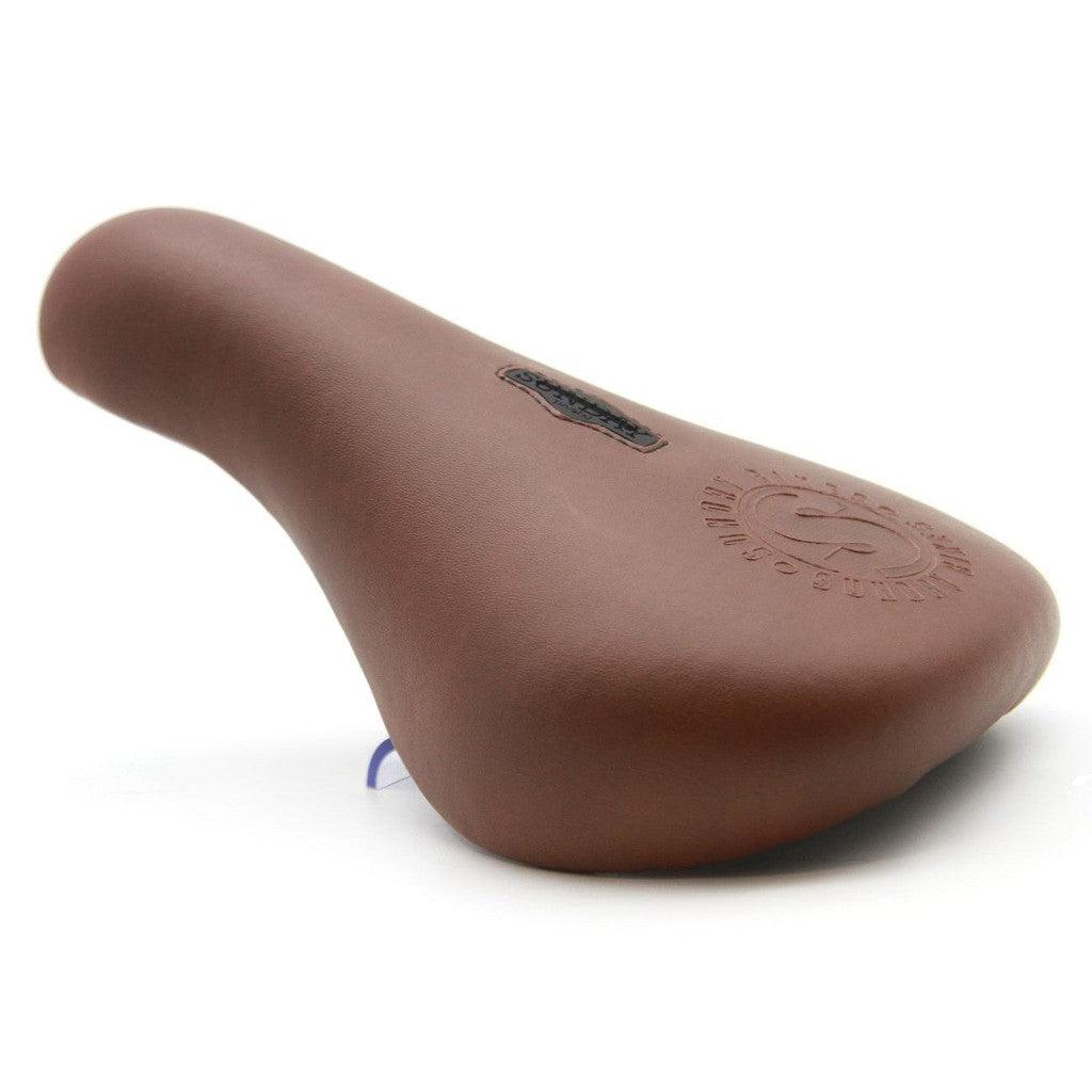A brown Sunday S Badge Pivotal Seat on a white background, perfect for a Sunday ride.