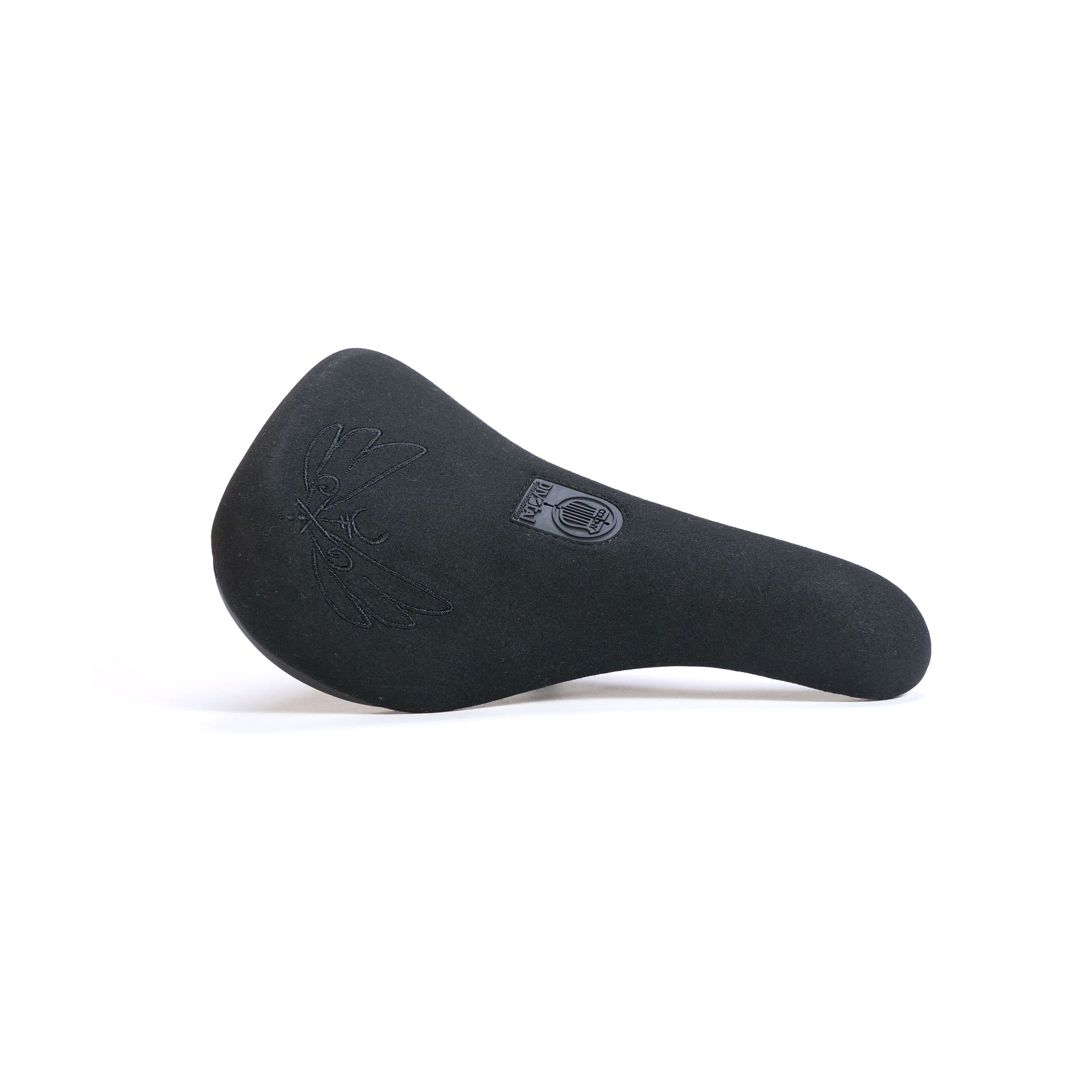 The Colony Sigil Pivotal Seat (Sean Gardner Signature) is black with an embossed pattern and a small logo near the center, displayed against a plain white background.