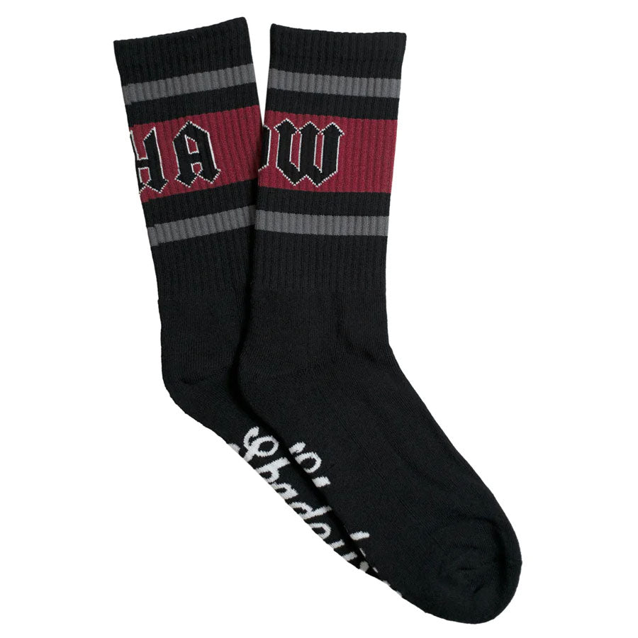 A pair of Shadow Conspiracy Benighted Crew Socks with a red stripe on them.