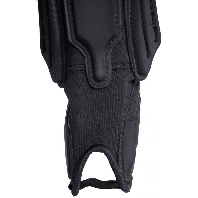 Close-up of a black Shadow Invisa-Lite Shin/Ankle Pad featuring reinforced stitching, thumb hole, and breathable neoprene padding. Enhanced with 3D impact foam for superior protection.