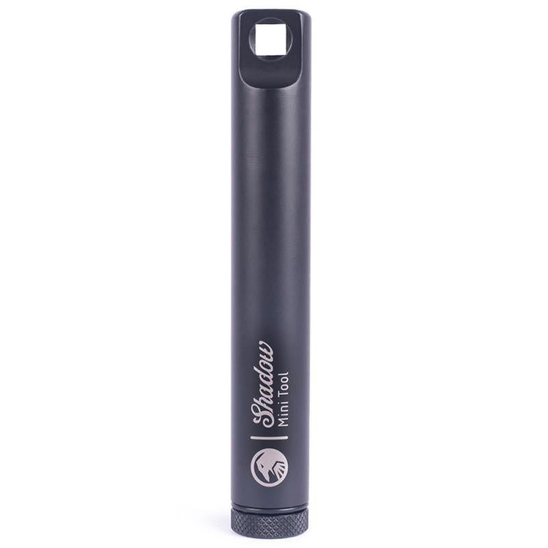 The Shadow Mini Tool is a black cylindrical gadget featuring a square cutout on the top and a textured grip at the base.