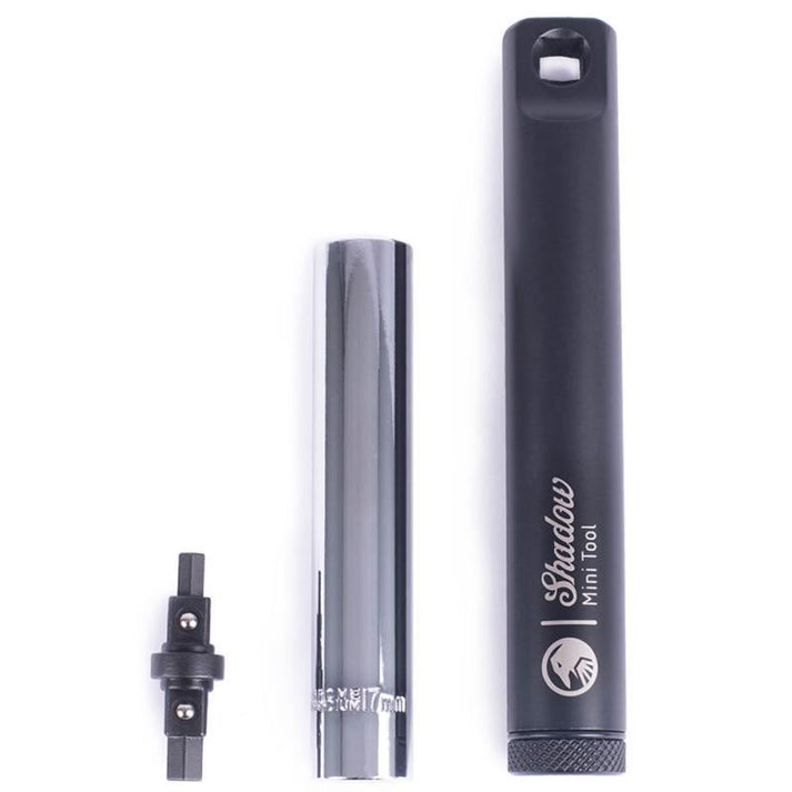 The Shadow Mini Tool is showcased on a white background, featuring a black handle, silver extension with size markings, and a small black attachment.