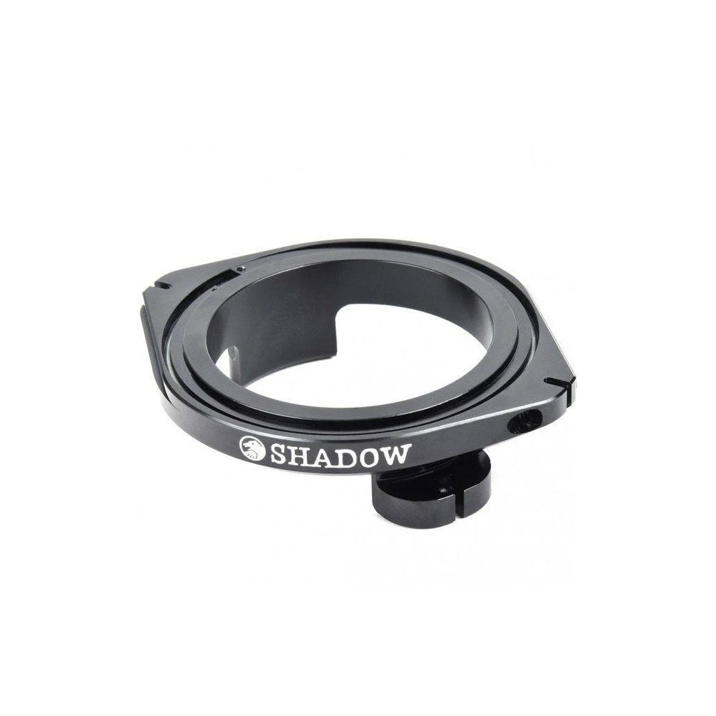 The Shadow Sano Detangler V2 is a black BMX fork top cap featuring a white "SHADOW" logo with a circular design and mounting bolt, enhanced by a precision-sealed mechanism for smooth performance.