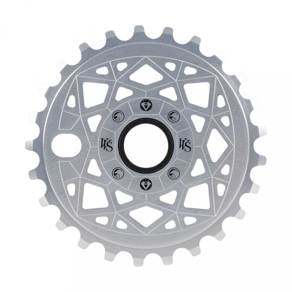 The silver Shadow VVS Sprocket, made from 7075 alloy, features a geometric cutout design with multiple teeth around the edge and showcases the Shadow branding in the center.