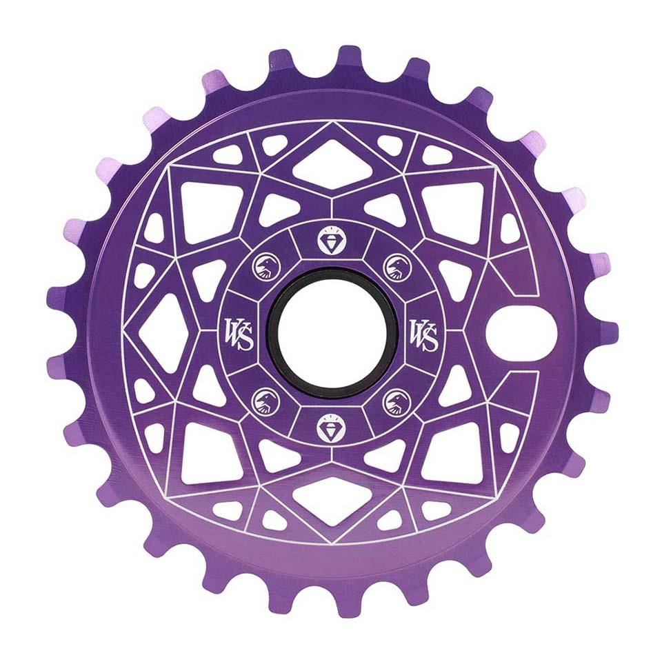The Shadow VVS Sprocket is a purple bicycle sprocket with geometric cutouts and a sleek white line design. It's crafted from durable 7075 alloy, featuring a central circular hole surrounded by intricate details, blending form and function beautifully.