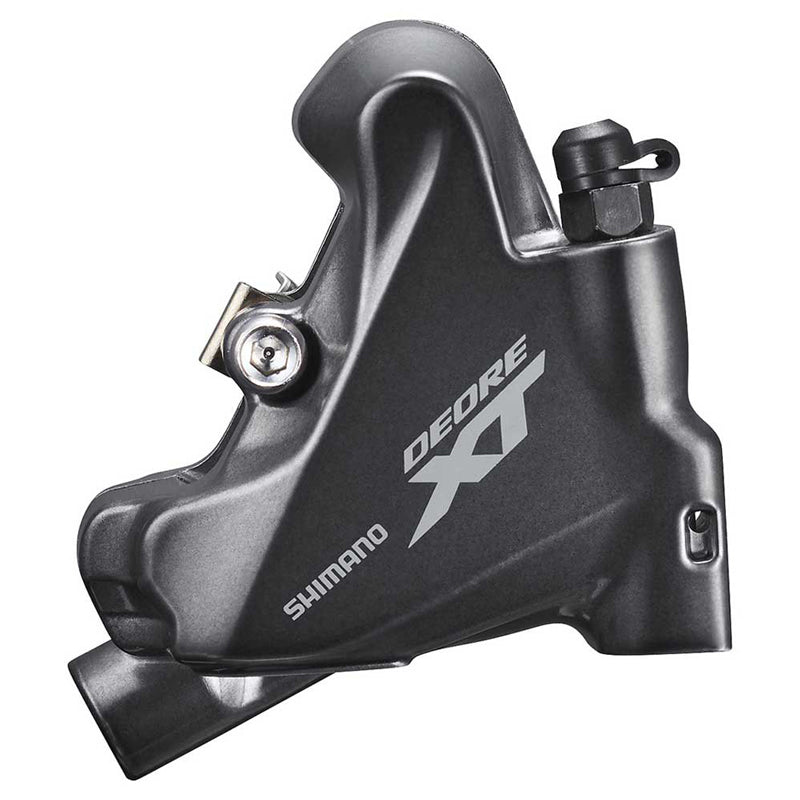 Close-up of the Shimano Deore XT Flat Mount Disc Brake Caliper in matte black, showcasing the branding, detailed hardware, and a portion of the disc brake rotor.