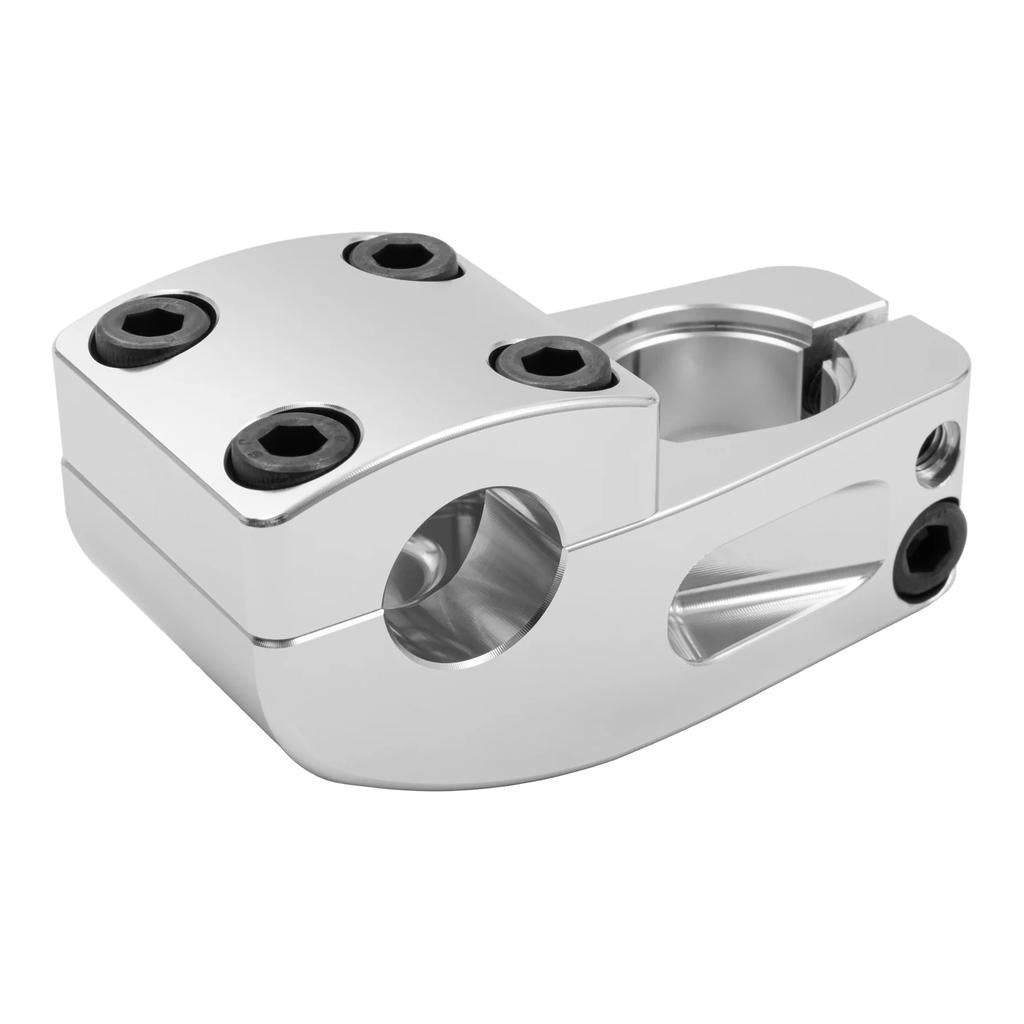 The Odyssey Broc Raiford V2 Stem is a polished metal clamp with four black hex bolts and a cylindrical opening, made to secure tubular BMX components and improve handlebar grip.