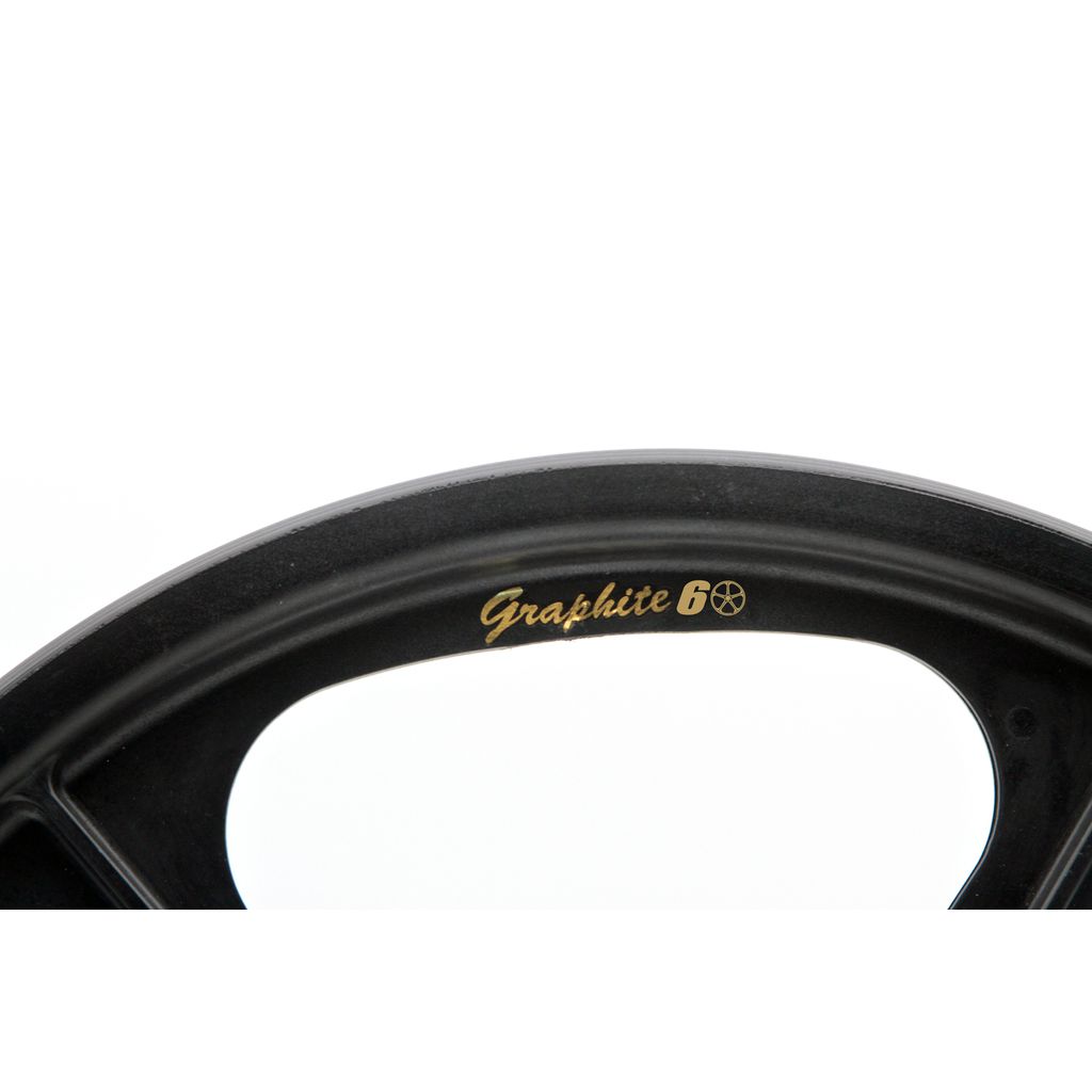 Close-up of a black circular object with "Graphite 60" in gold, celebrating the Skyway TUFF II 60th Anniversary Graphite Edition 20 Inch Wheel Set.