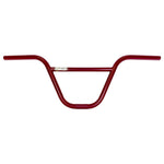 The S&M No Exit Bars are red BMX handlebars with a crossbar and a central small gold "SE Bikes" logo, made from robust 4130 CrMo for maximum strength.