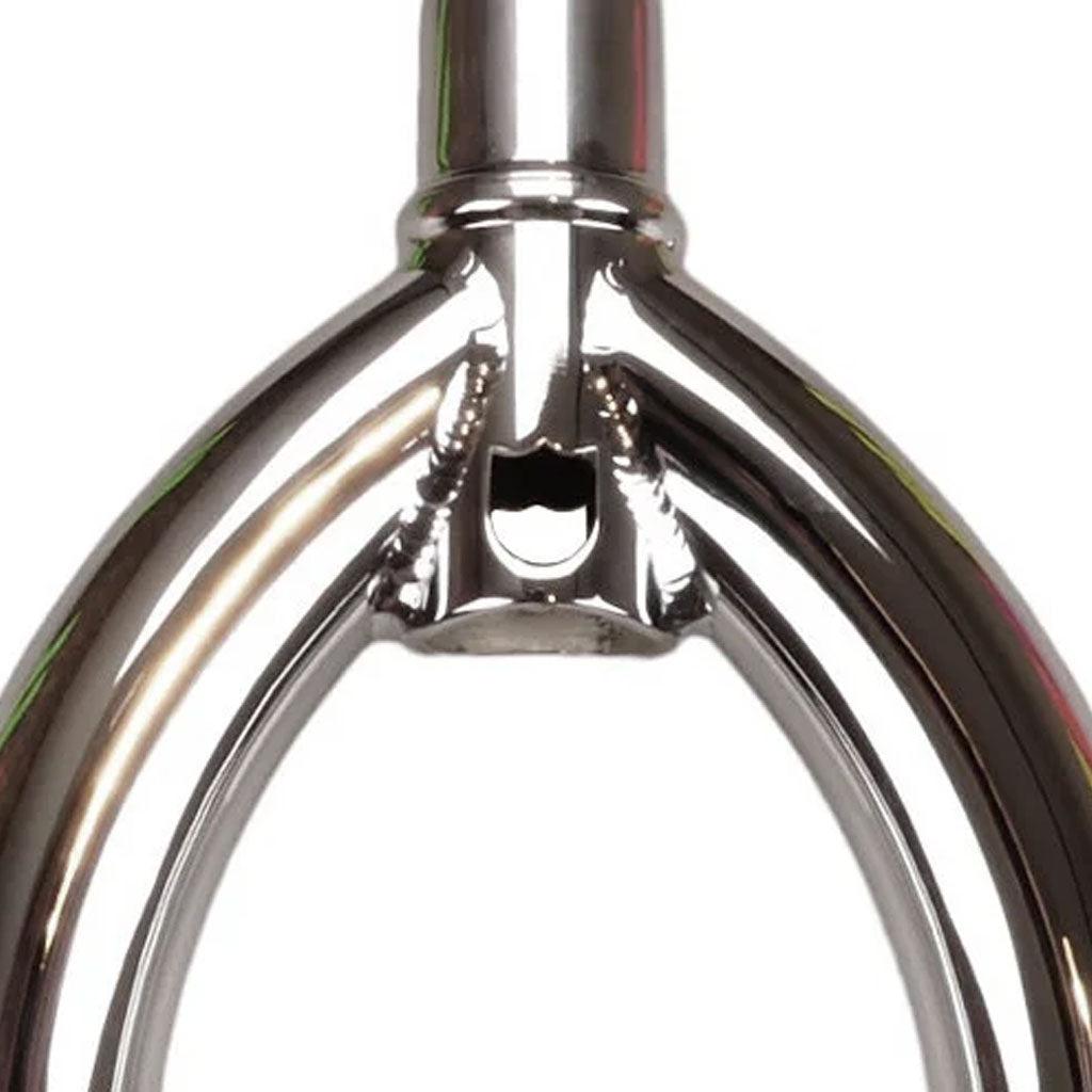 Close-up of a polished metal fork with a geometric design at the joint, reminiscent of the limited-edition S&M Pitchfork Shield Fork crafted from 4130 CrMo steel.