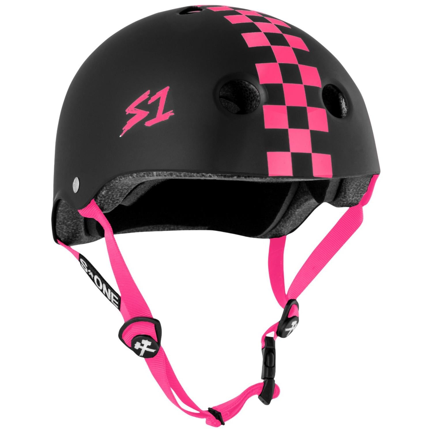 The S-One Lifer Helmet in Matte/Pink Checkers features a pink checkered stripe, pink "S1" logo, pink straps, vents, adjustable buckle, and certified multi-impact protection for safety and style.