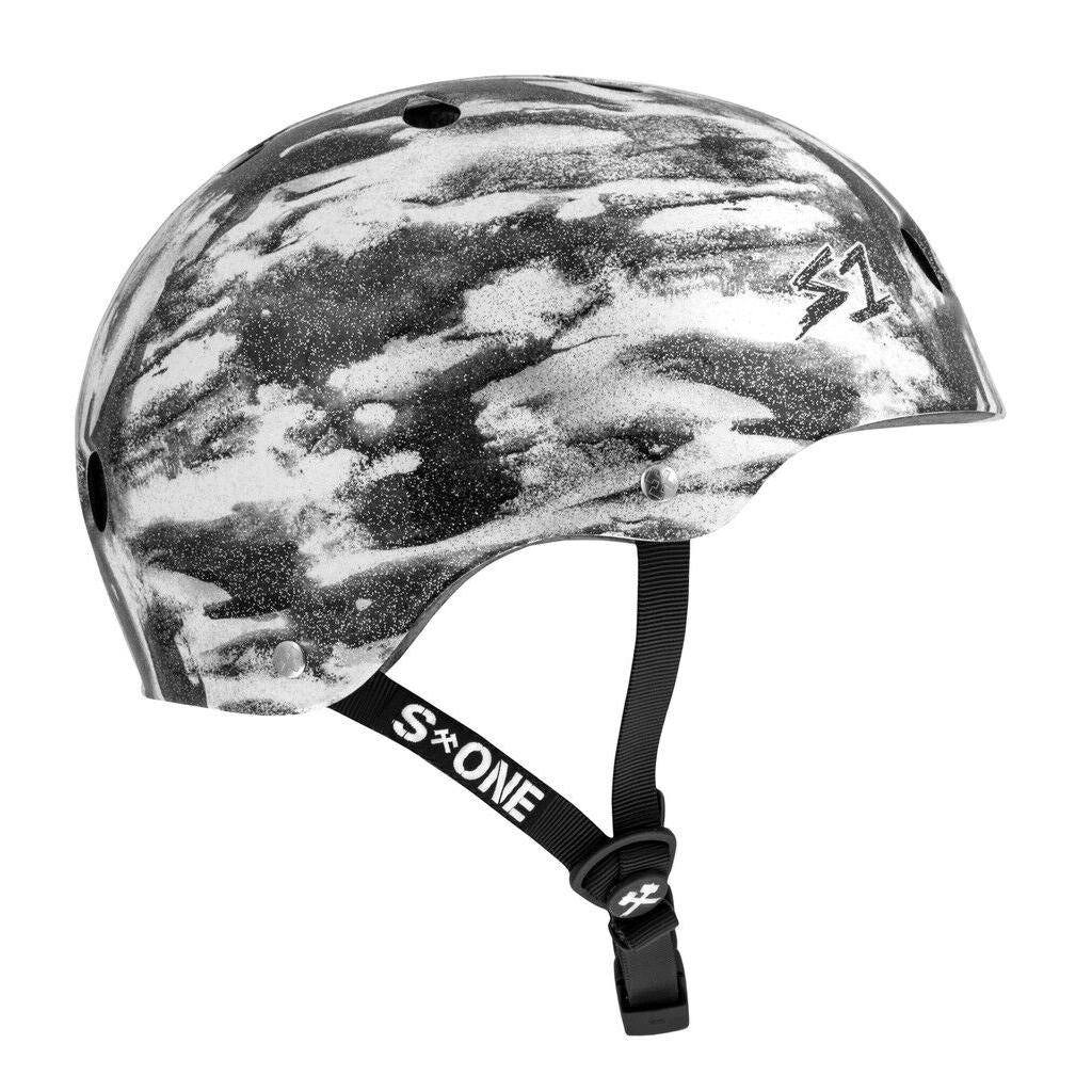 The S-One Lifer Helmet in Black White Glitter/Bomba Hache offers ventilation holes, multi-impact protection, and an adjustable chin strap.