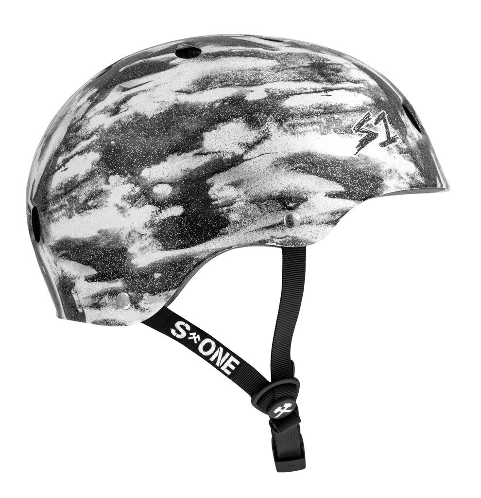 The S-One Lifer Helmet in Black White Glitter/Bomba Hache offers ventilation holes, multi-impact protection, and an adjustable chin strap.