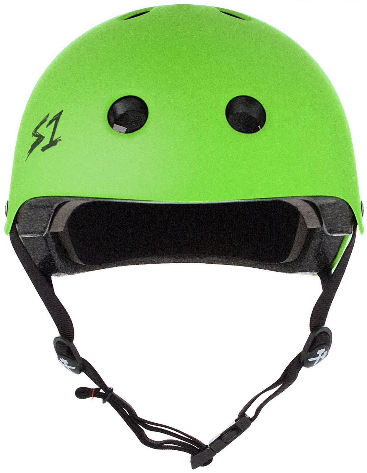 The S-One Lifer Helmet in Bright Green Matte features black vents, a black "S1" logo on the left, and an adjustable black chin strap, providing certified multi-impact protection for skating.